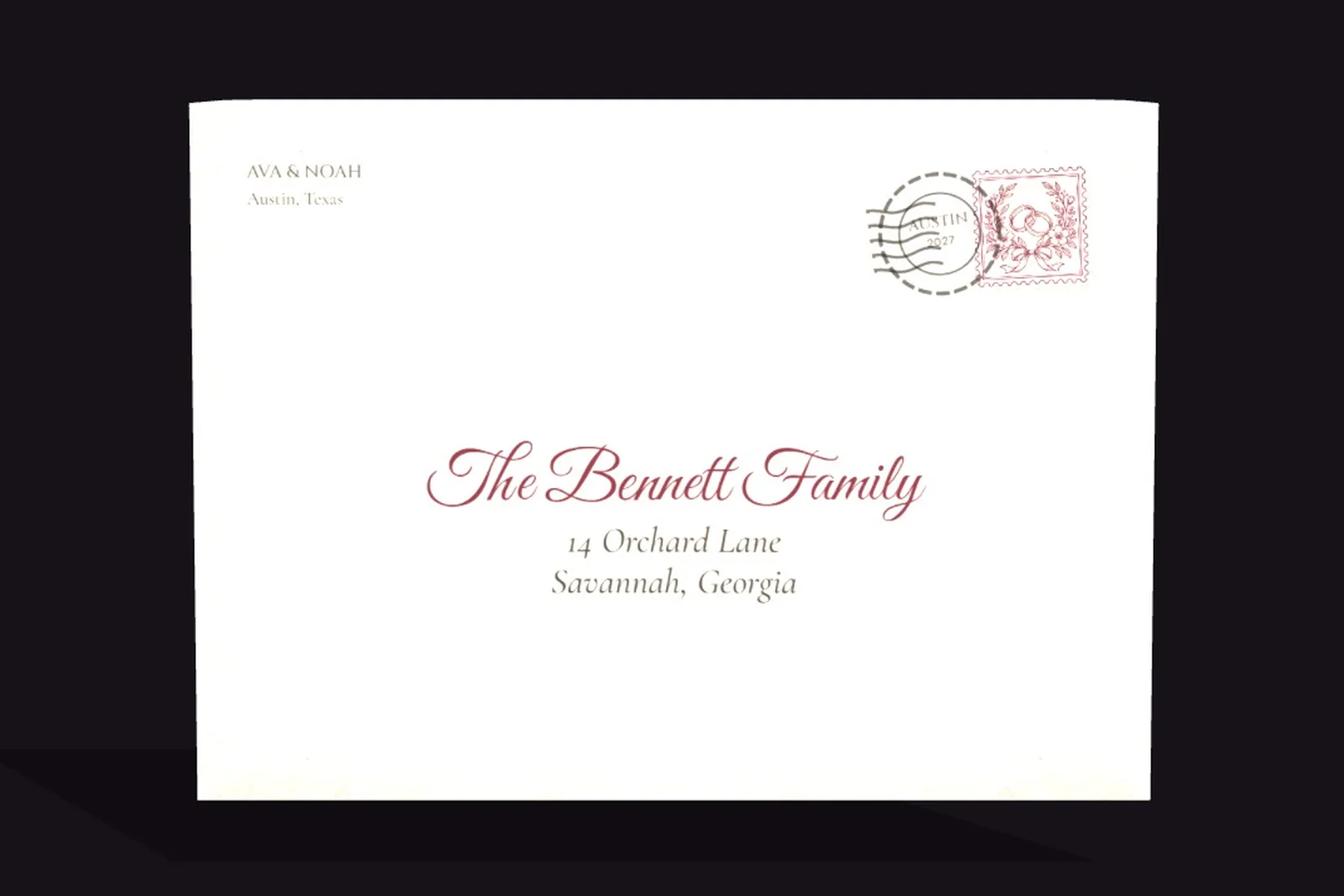 An envelope addressed by hand to a family, with a stamp and postmark